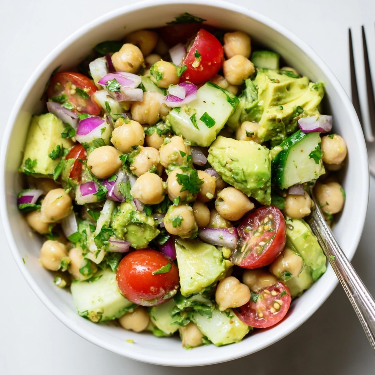 Close-up of vibrant Chickpea Avocado Salad, bursting with freshness and zesty lemon aroma.