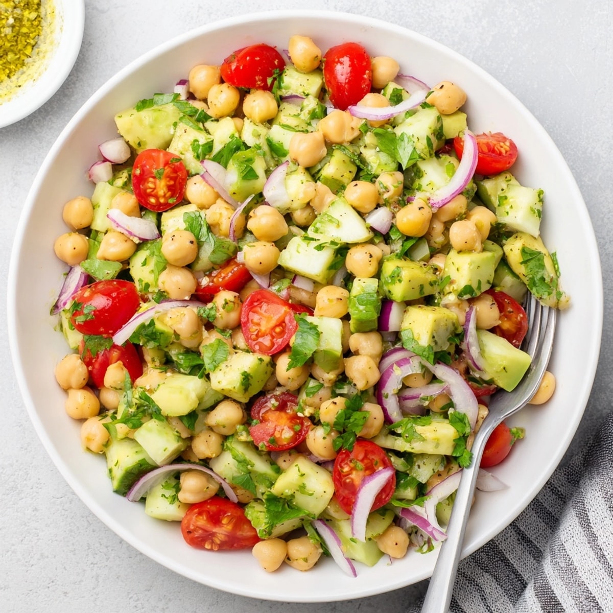 Tangy lemon dressing glistens on this fresh Chickpea Avocado Salad, a quick, vegan dish.