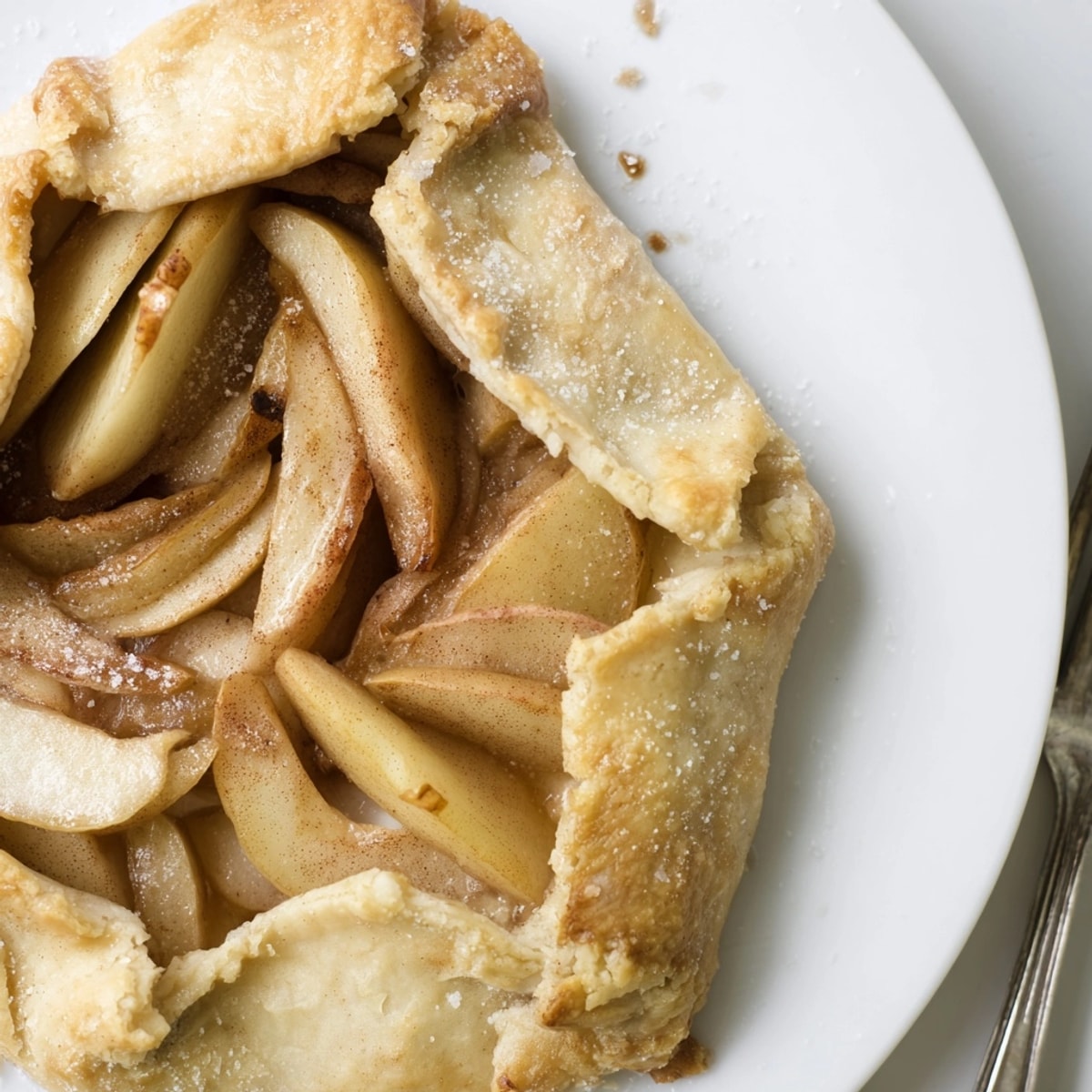 Homemade Apple Cinnamon Galette, speckled with cinnamon, ready for a comforting autumn treat.