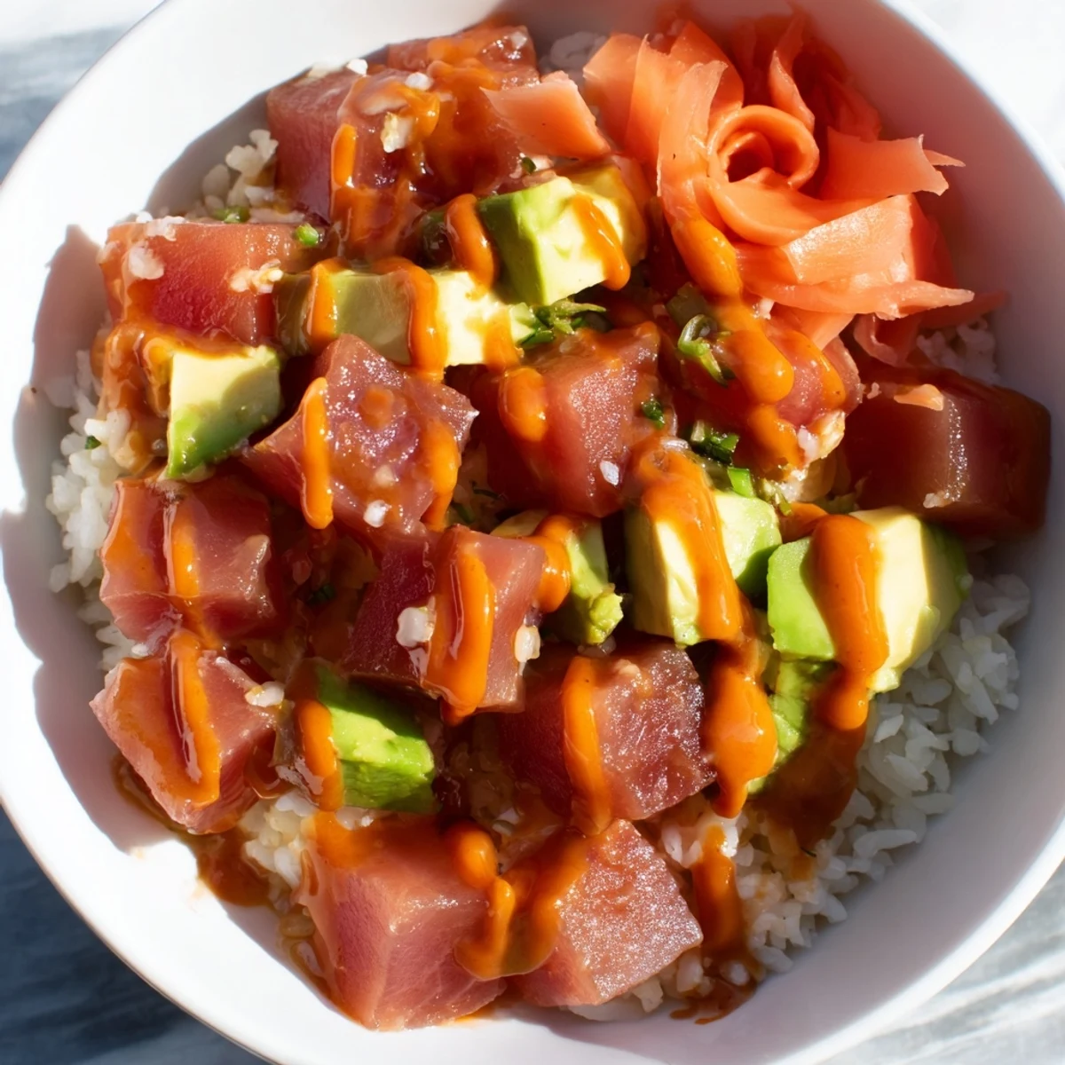 Lunchtime favorite Spicy Tuna Poke Bowl featuring colorful veggies, spicy mayo drizzle, and a perfect balance of heat and cool textures.