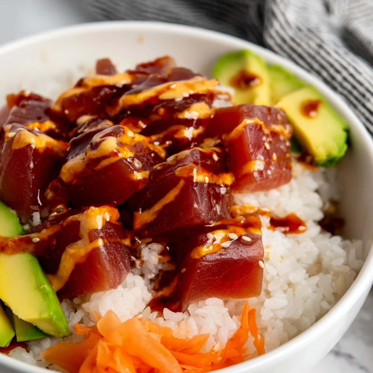 Freshly diced sushi-grade tuna marinated in sesame and soy, piled high in a Spicy Tuna Poke Bowl with edamame and pickled ginger.