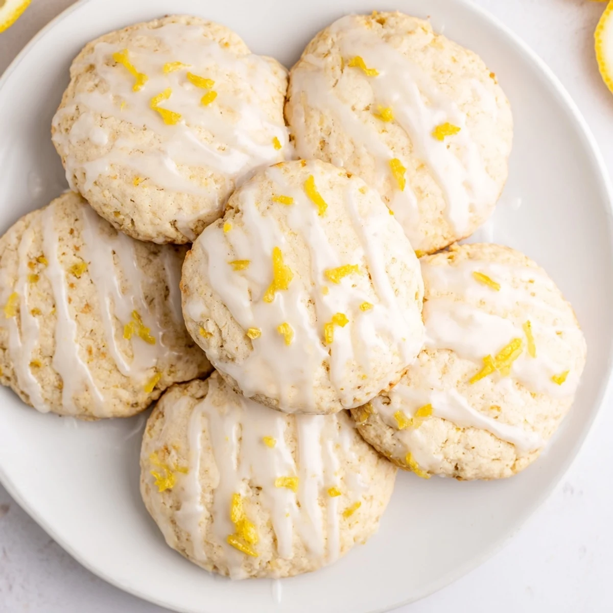 Stack of homemade Italian-American lemon ricotta cookies drizzled with glossy glaze, perfect with afternoon tea or as a light dessert.