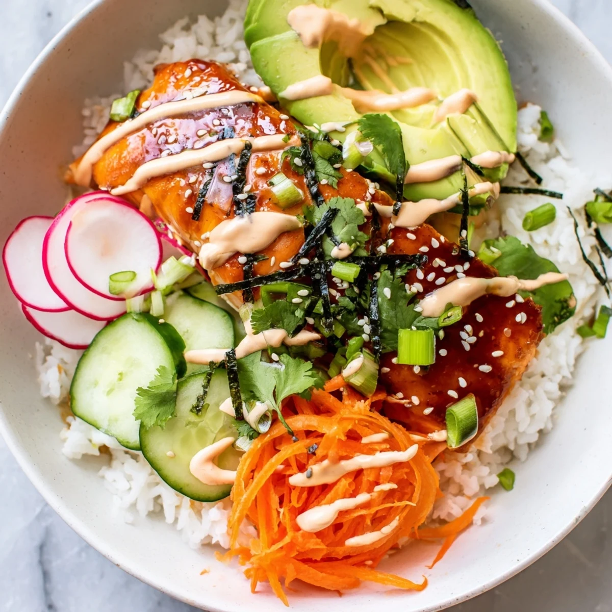 Tender teriyaki salmon and fluffy jasmine rice topped with pickled veggies and sriracha mayo in a vibrant bowl.