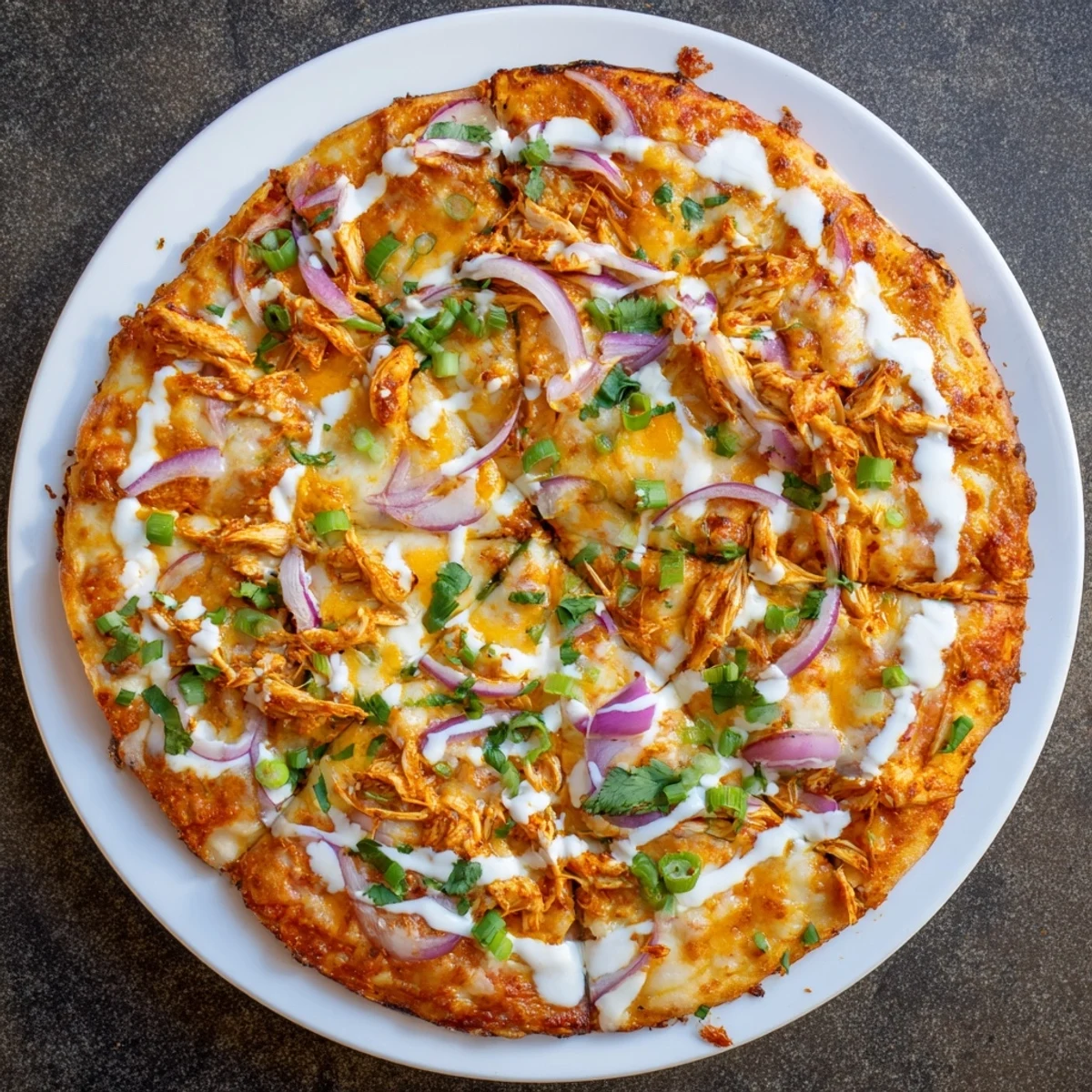 Golden, bubbly Bold Buffalo Chicken Pizza fresh from the oven with melted mozzarella and cheddar.