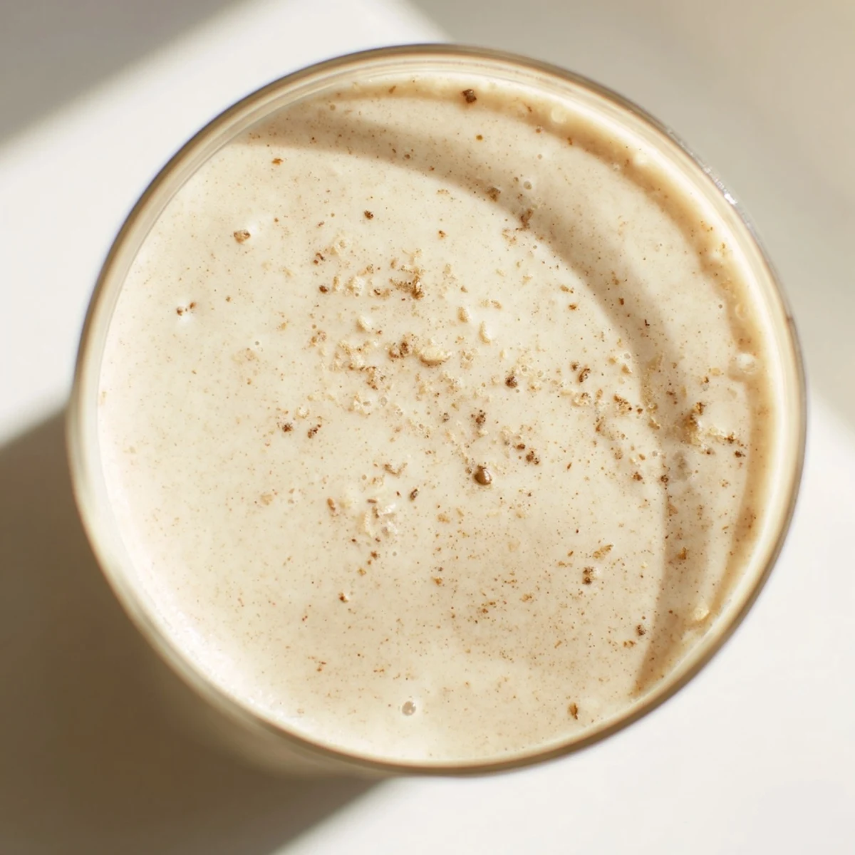 Thick protein-rich Greek yogurt banana smoothie blended with ice and drizzled with honey