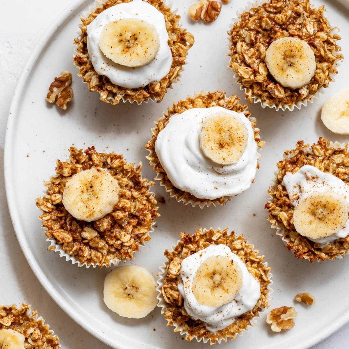 Portable oatmeal breakfast cups studded with ripe banana slices and creamy yogurt topping