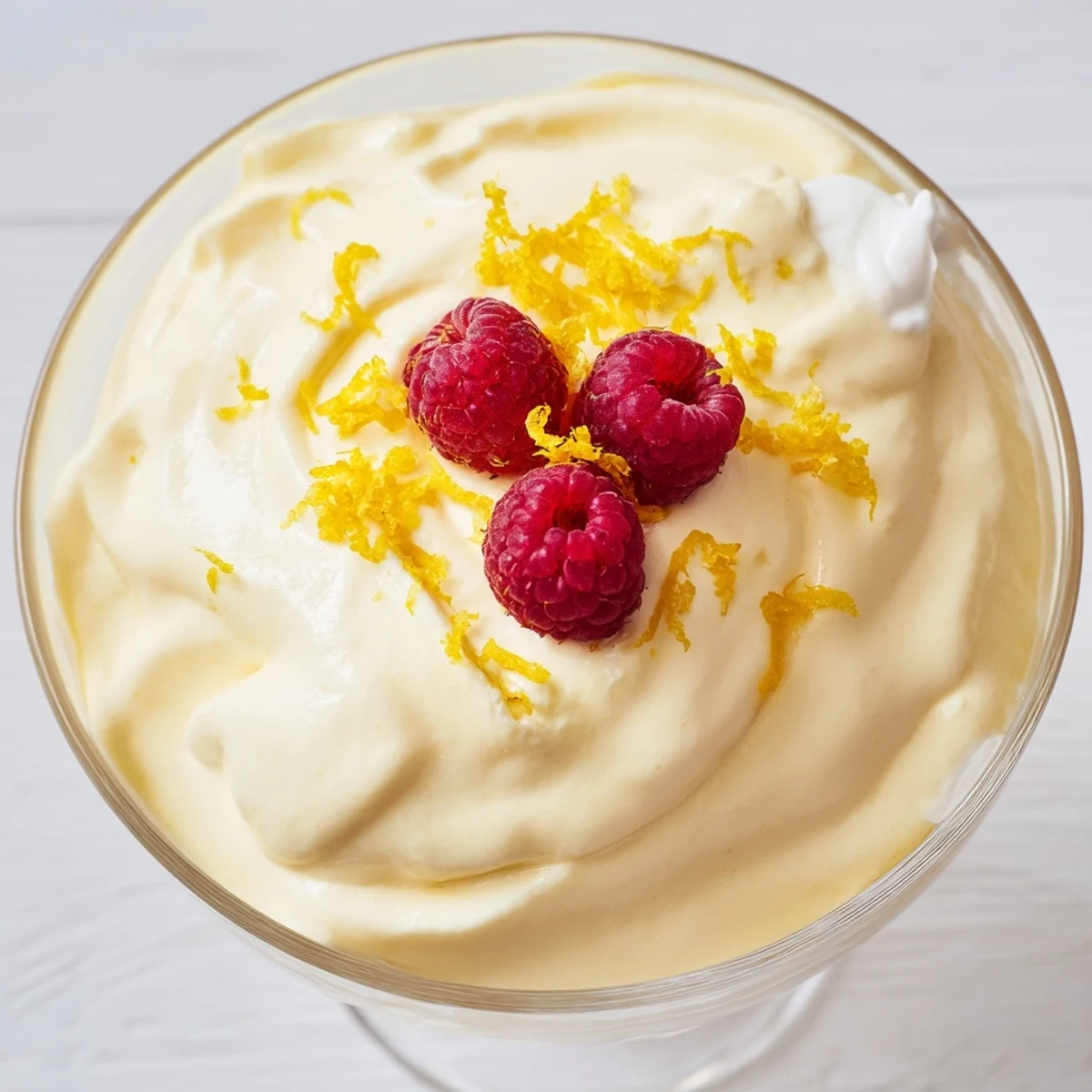 Light and fluffy lemon cheesecake mousse dessert garnished with graham cracker crumbs