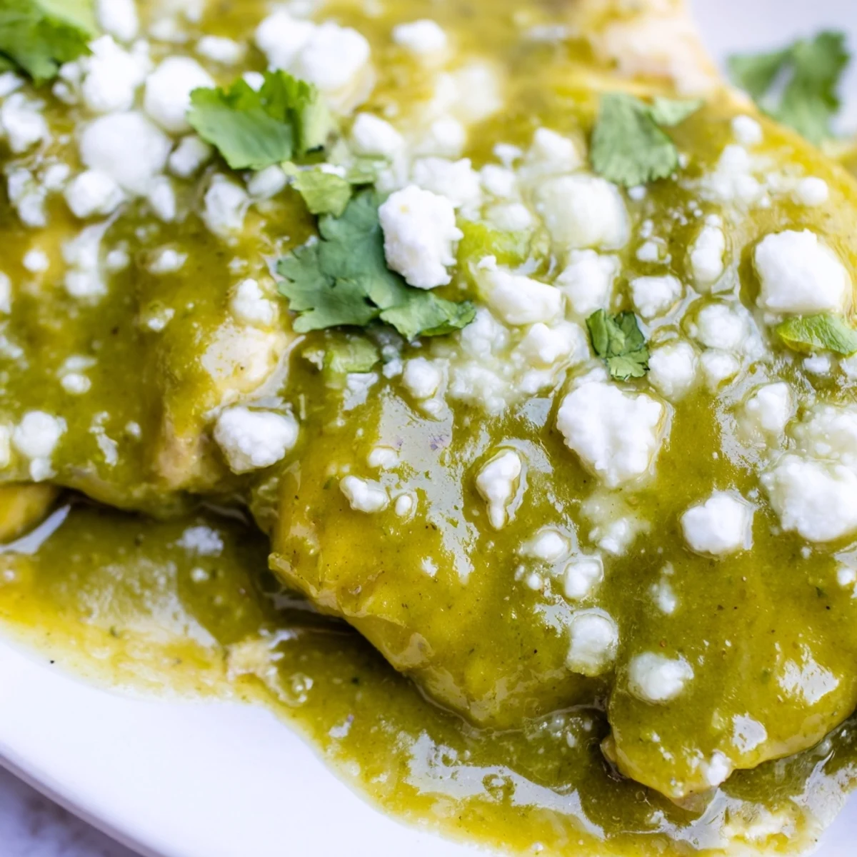 Weeknight dinner featuring juicy chicken cooked in zesty salsa verde with sliced onions and peppers