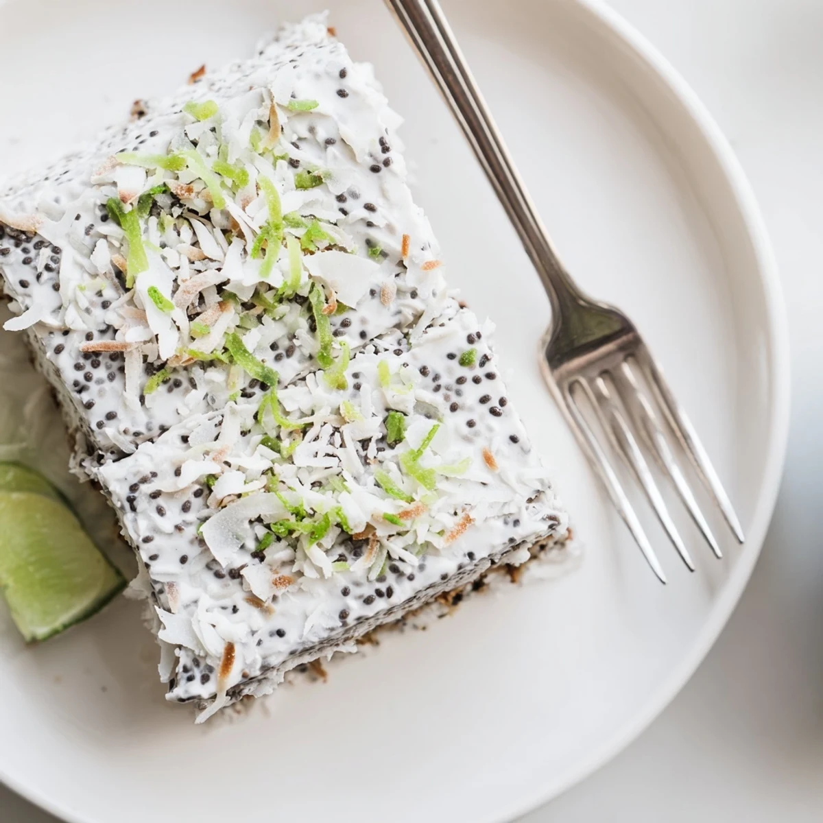 Golden no bake zesty coconut lime chia pudding bars topped with toasted coconut flakes