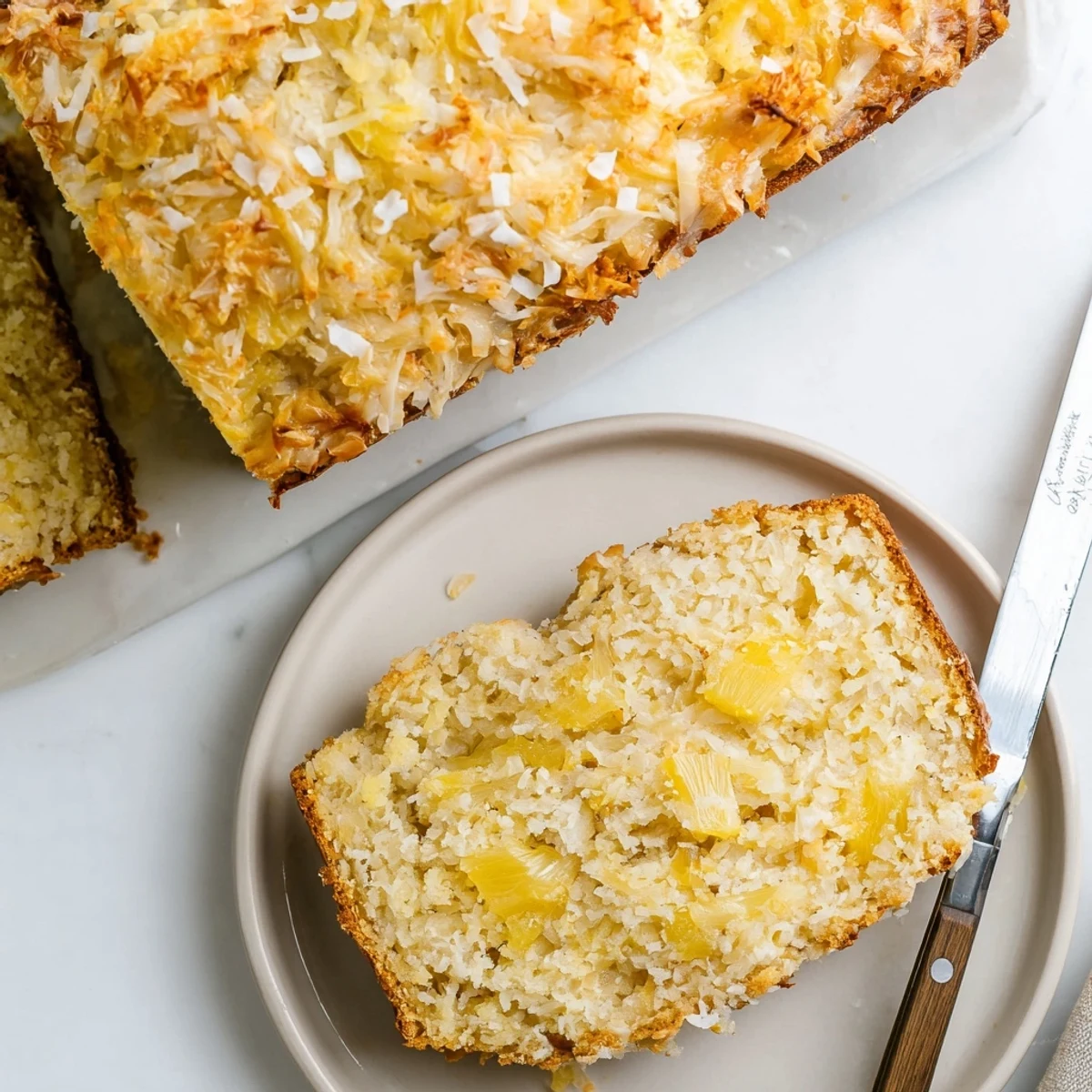Freshly baked pineapple coconut bread on a wooden cutting board ready for breakfast or snacking