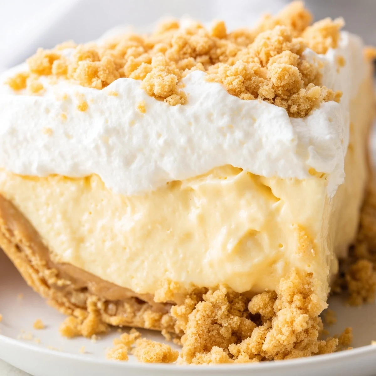 Creamy Amish Peanut Butter Dream Pie topped with fluffy whipped cream and golden peanut butter crumbles