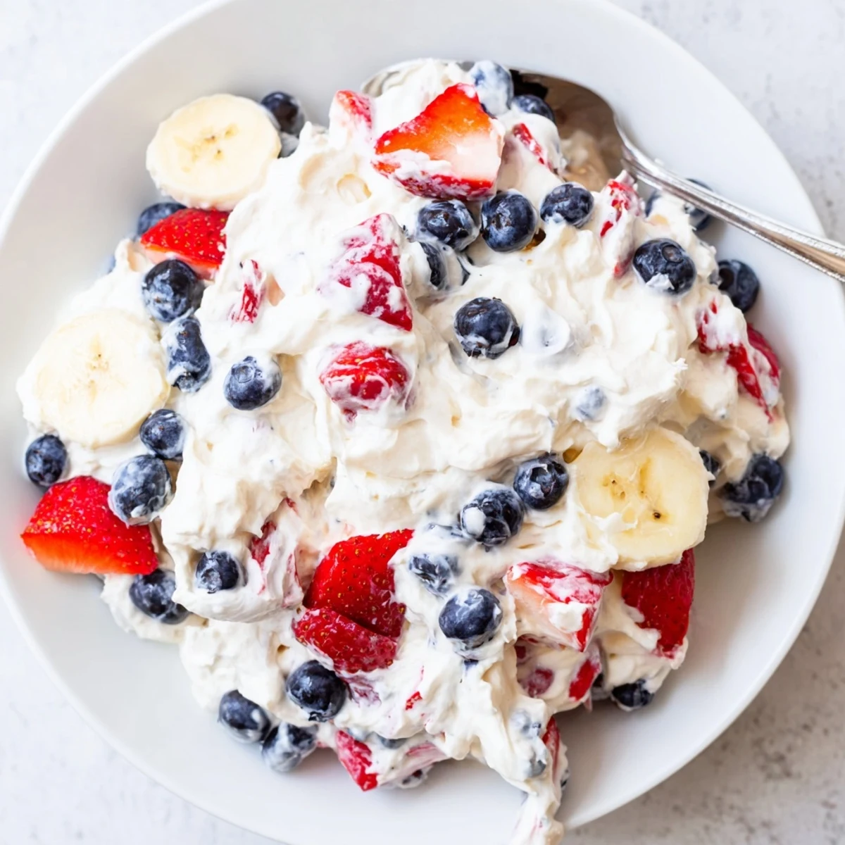 Red White And Blue Cheesecake Salad: creamy filling studded with juicy strawberries, blueberries.