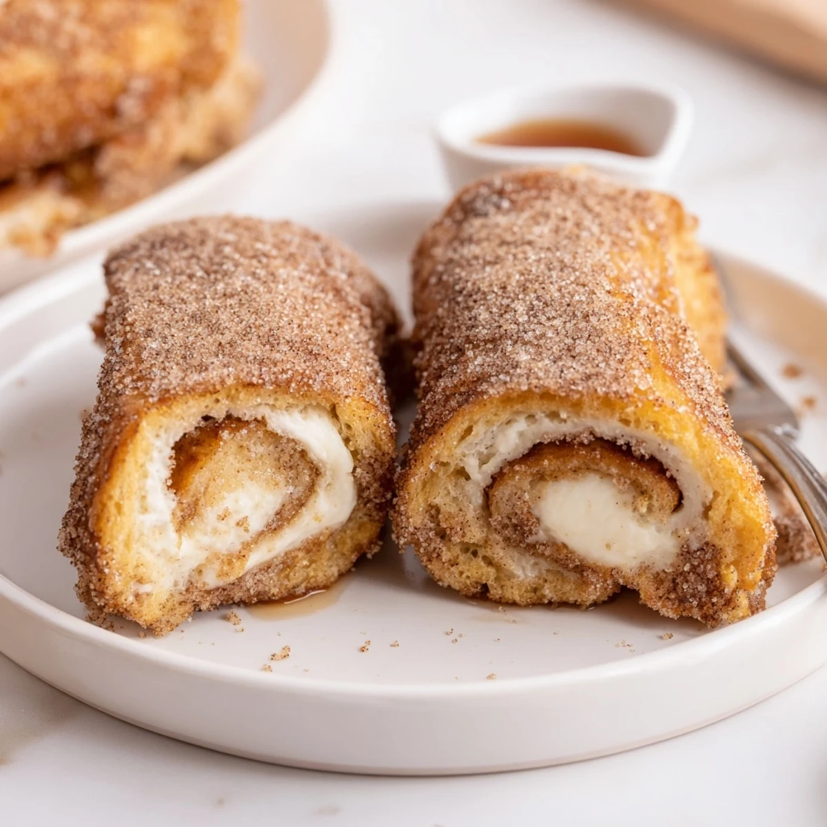 Warm Cinnamon Roll French Toast Roll Ups, golden edges, cinnamon sugar coating