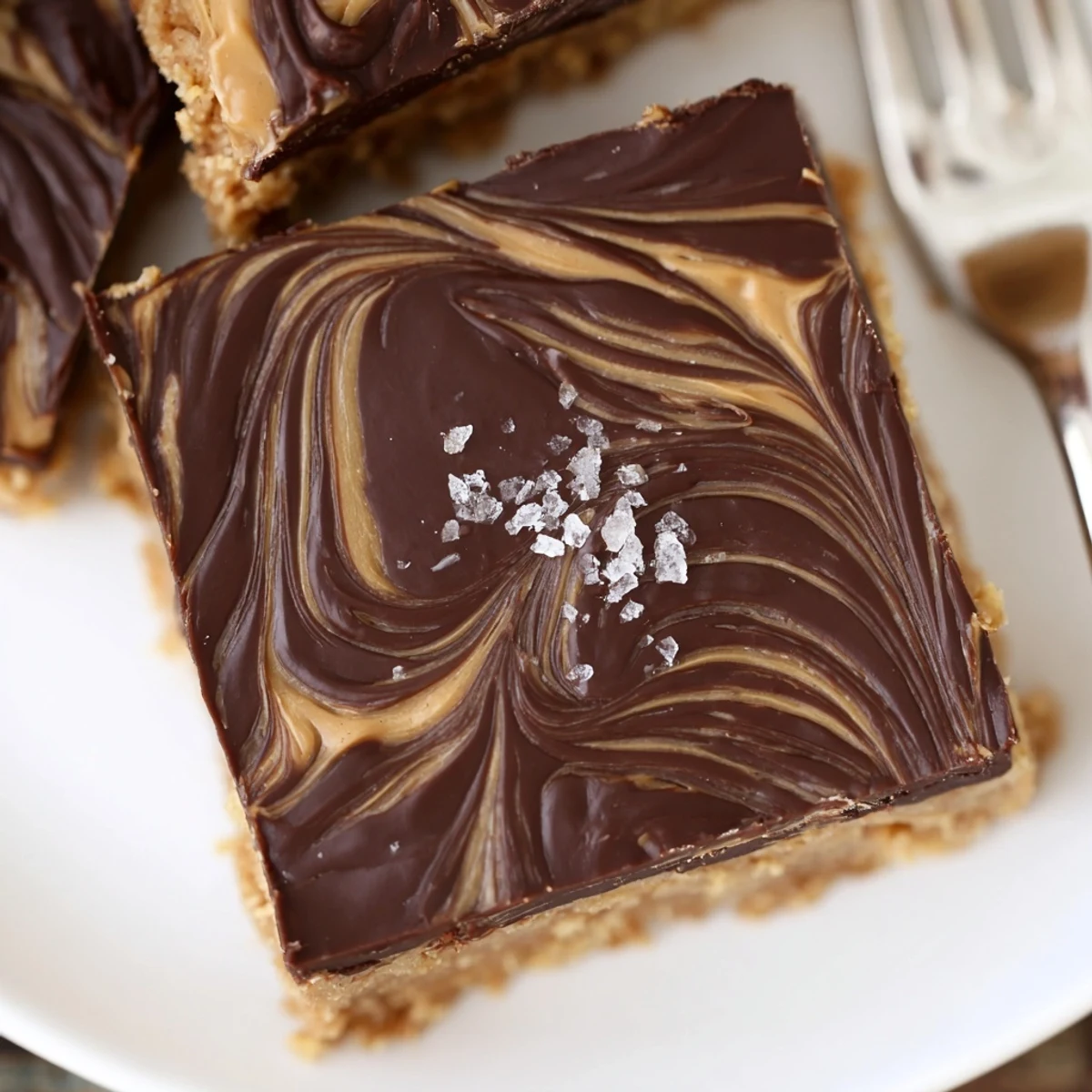 Warm coffee beside plate with No Bake Peanut Butter Bars, nutty, dense bites