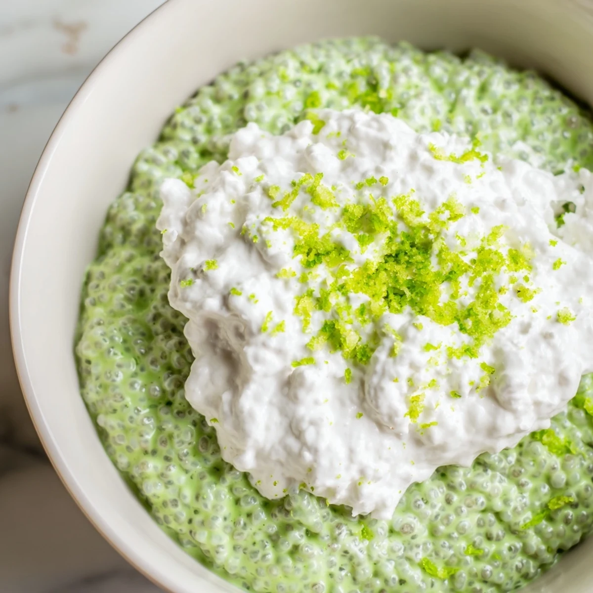 Vegan key lime chia pudding layered with crushed graham crackers and bright citrus garnish