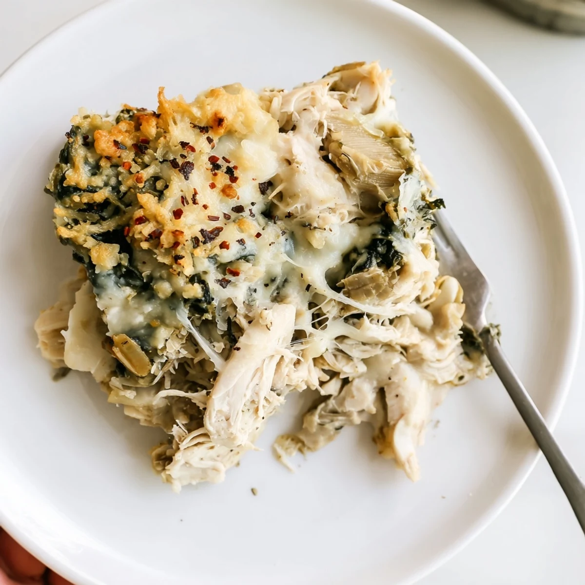 Family style Spinach Artichoke Chicken Casserole served warm with crusty bread