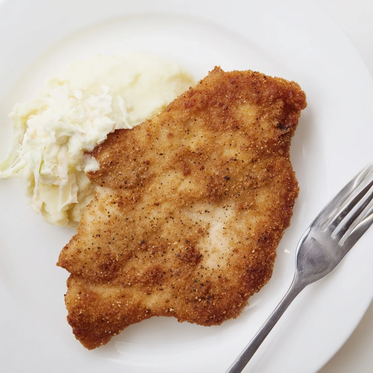 Skillet crisp Fried Chicken Breast resting on paper towels, served with mashed potatoes