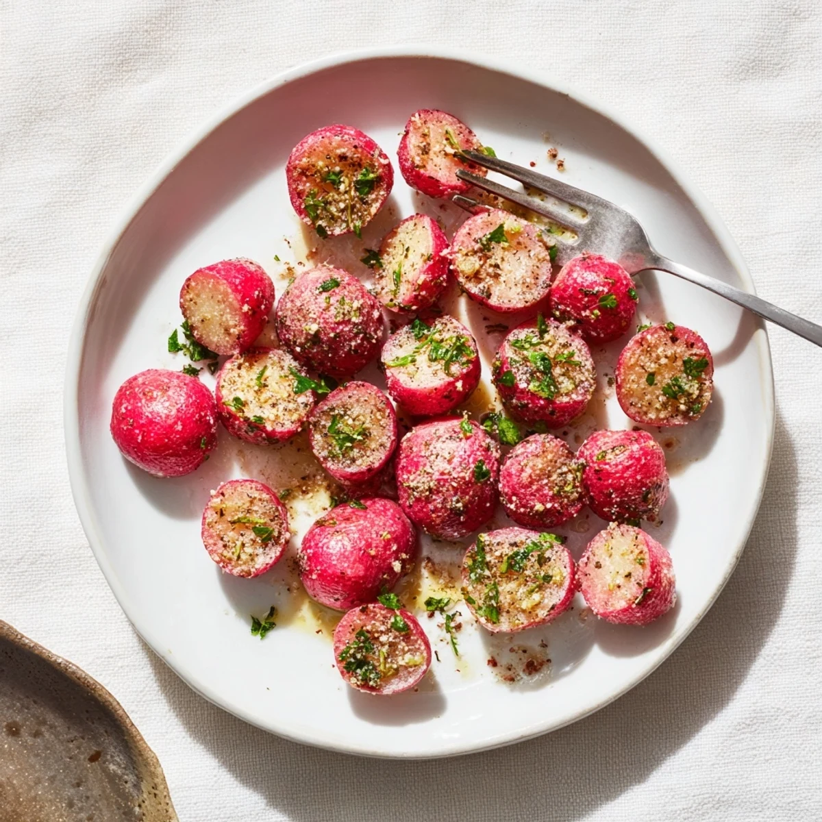 Garlic Roasted Radishes glistening with olive oil, golden edges and chopped parsley  