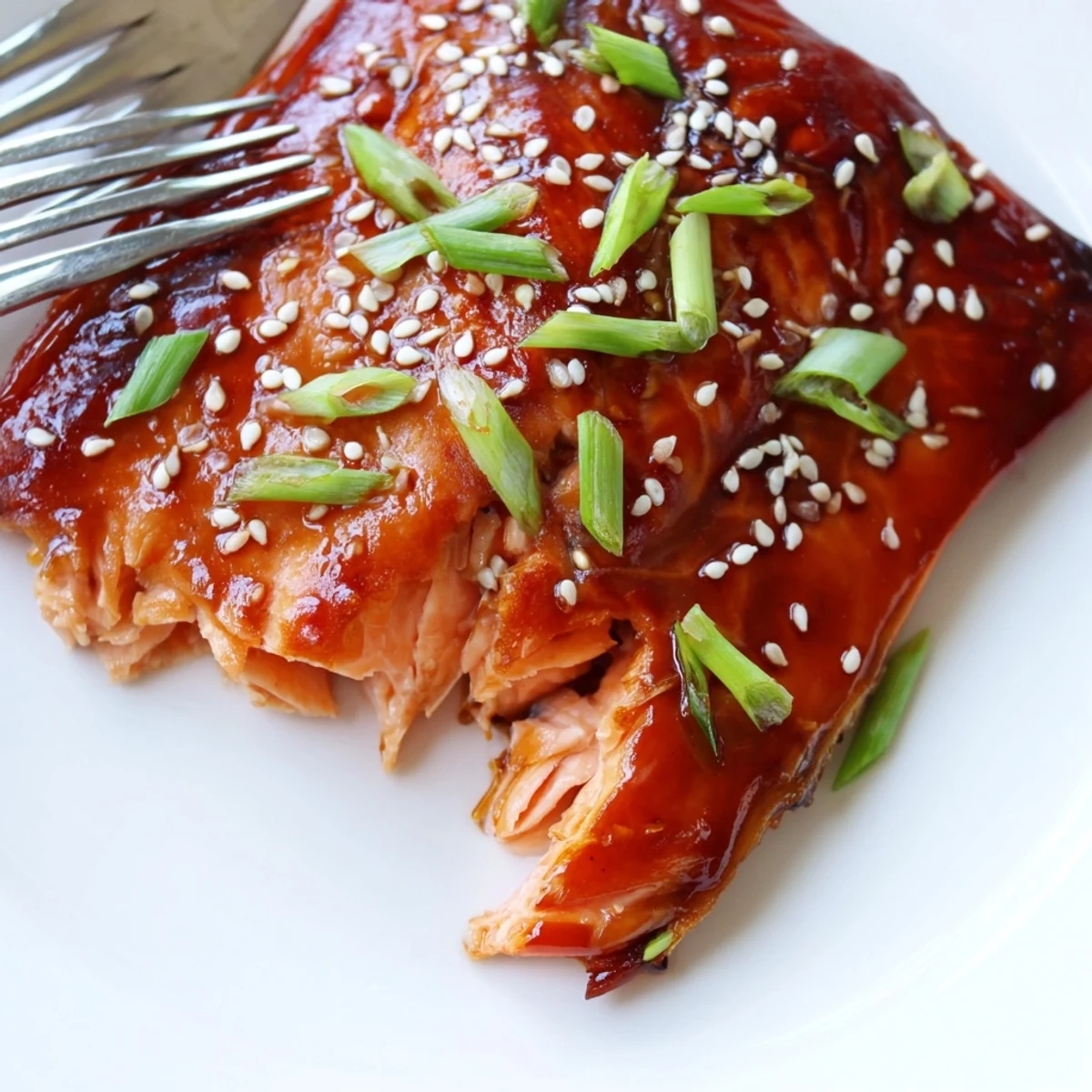 Glossy baked Asian salmon fillet glistening with a sticky soy glaze and sesame seeds
