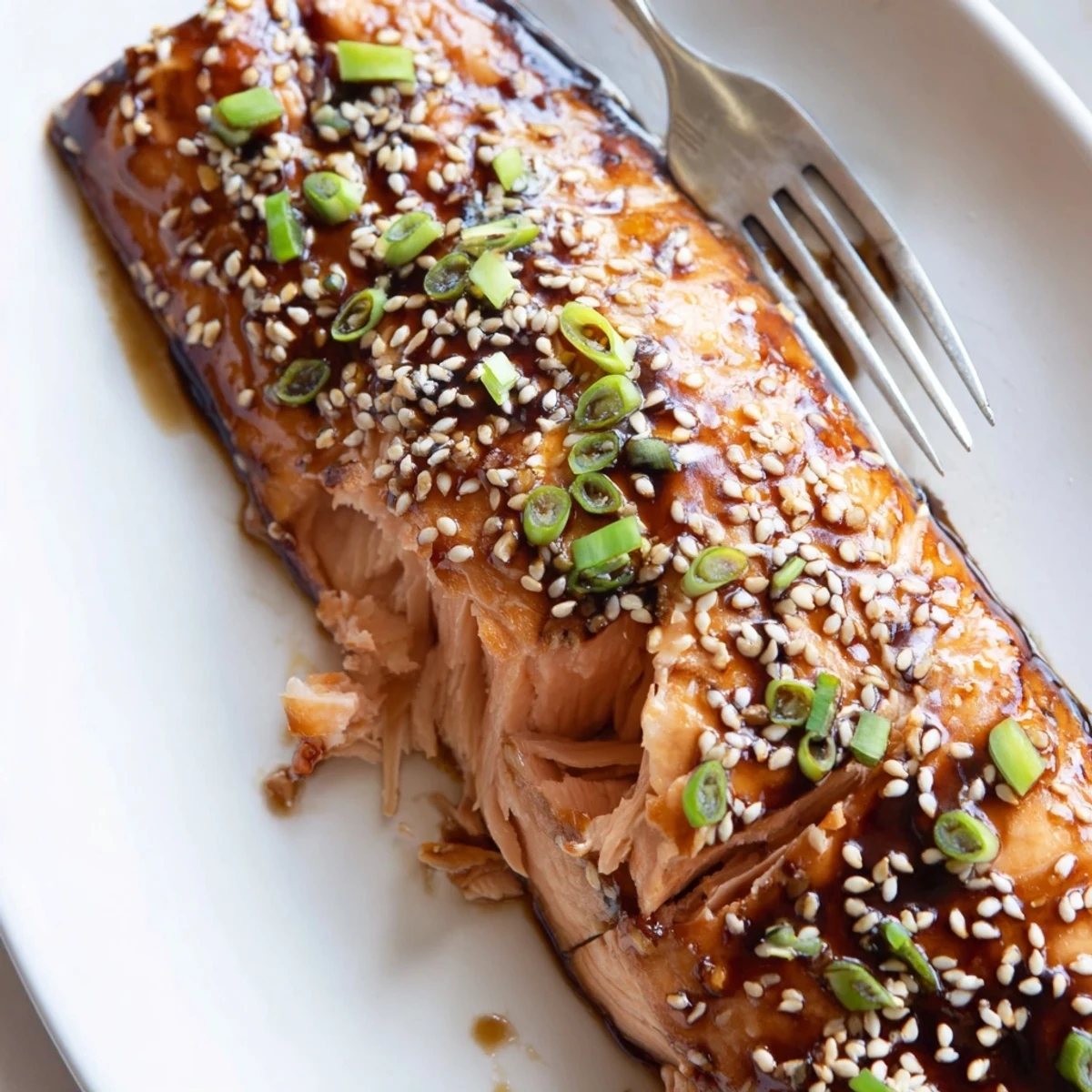 Tender baked Asian salmon flaking beautifully beside steamed rice and sautéed vegetables