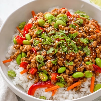 Colorful ground turkey rice bowls with tender vegetables in a savory soy glaze